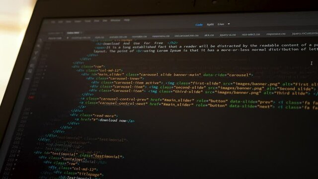 Developer is browsing html code on the computer screen. HTML Web Page Code Scrolling Programming code abstract technology background for software developer and Computer script concept. Scene Z.