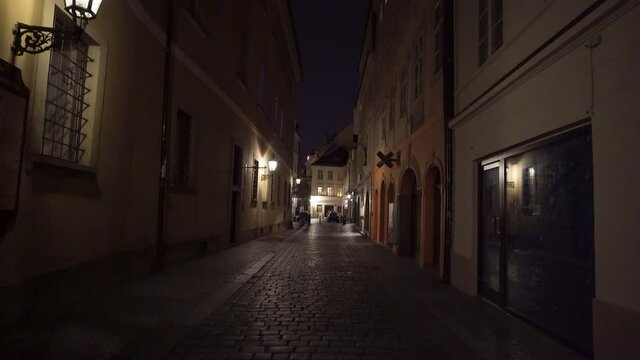 Empty narrow street in Prague center lit by lanterns,Czechia,lockdown.