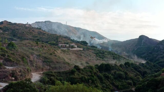 Water-Dropping Plane Fights Wildfire on Hillside