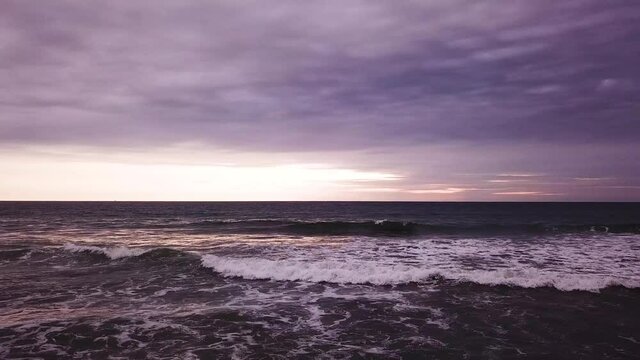 Perfect purple over the waves of Ecuador from Olon Beach -low aerial