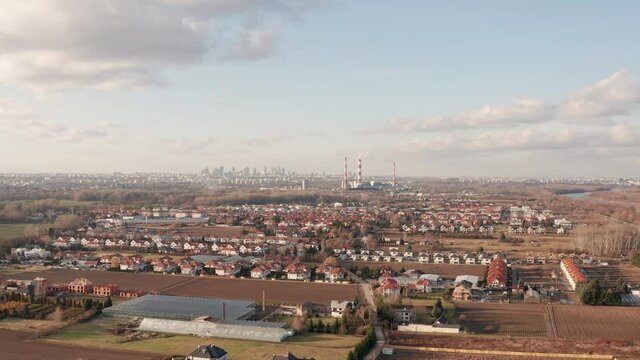 Drone shoot of suburbs in Warsaw, with heat and power plant in the backgroun.