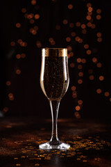 selective focus of glasses full of champagne against christmas lights.