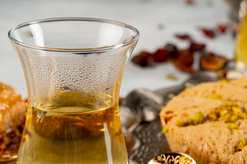 Glass cup of tes and turkish desserts on table