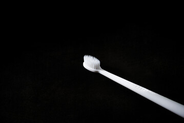 new white toothbrush on dark background