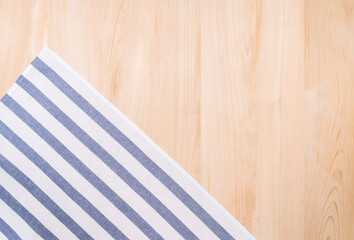 Top view of hand towel and wooden background
