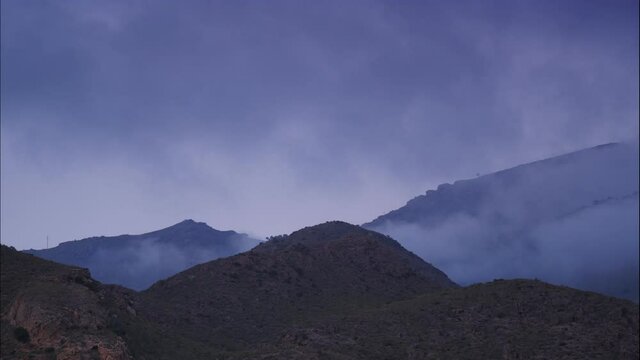 Time lapse of clouds moving over Sierra Alhamilla mountain range, Spain. Evening landscape