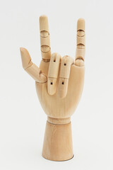Wooden hand show love symbol on off white background