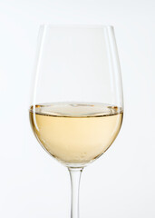Glass of white wine on white background