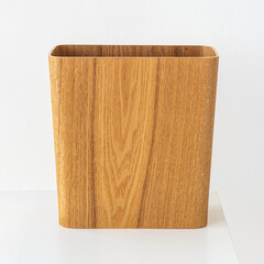 Wooden rectangular dustbin on off white background