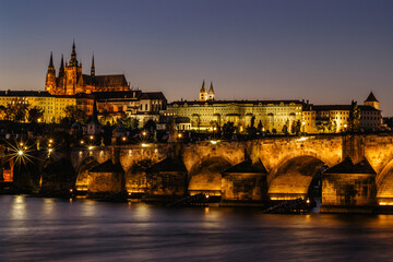 Postcard view of night Prague panorama, capital of the Czech republic.Amazing European cityscape.Prague Castle,Charles Bridge,Vltava river at colorful sunset.Famous tourist destination.Night city