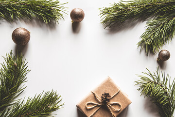 Gift box with christmas green framework and pine cones on white background. Copy space and Top view