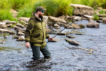 Man fishing in a mountain river