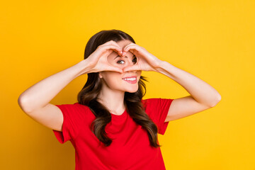 Photo of positive girl make fingers heart face look in camera love symbol isolated over bright shine color background