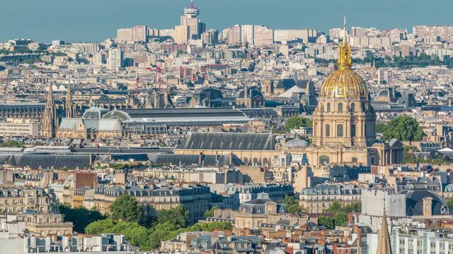 Aerial panorama above houses rooftops in a Paris timelapse. Evening view with les invalides bebore sunset