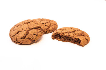 Broken brown cookies with cracks on a white background