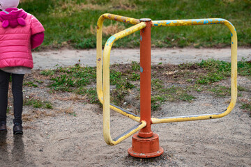 Old carousel on the playground. Self-isolation. An empty carousel with no children