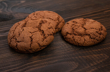 Brown cookies with cracks on a wooden background