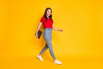 Fototapeta na wymiar Full length profile side photo of positive girl hold laptop go isolated bright shine color background