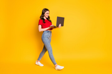 Full size profile side photo of positive girl go use laptop texting typing isolated over bright...