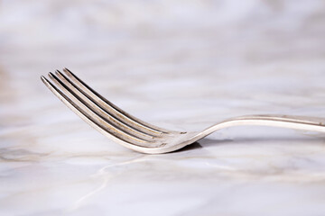 Vintage silver fork on marble bottom