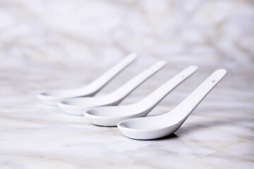 White earthenware spoon on marble background