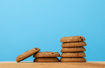 Stack of chocolate chip cookies against blue background