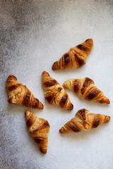 Freshly baked croissants on beautiful textured concrete background
