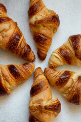 Freshly baked croissants on beautiful textured concrete background