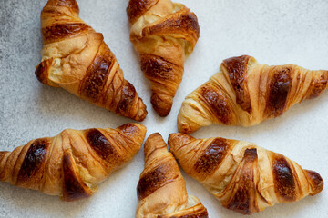 Freshly baked croissants on beautiful textured concrete background