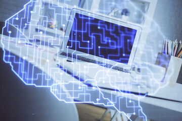 Double exposure of work space with computer and human brain drawing hologram. Brainstorm concept.