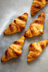 Freshly baked croissants on beautiful textured concrete background