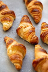 Freshly baked croissants on beautiful textured concrete background