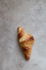 Freshly baked croissants on beautiful textured concrete background