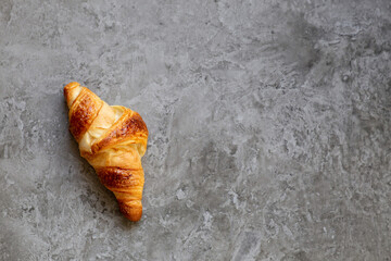 Freshly baked croissants on beautiful textured concrete background