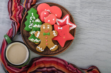 Christmas treat: gingerbread cookies and hot chocolate on a gray background.