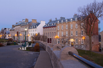 Fototapeta na wymiar Blue hour view of row of mid-19th Century houses on St. Denis Avenue seen from the Pierre-Dugua-de-Mons terrace, Quebec City, Quebec, Canada