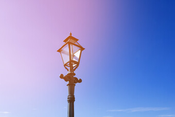Obraz premium Retro street lamp on clear blue sky background. Tinted.