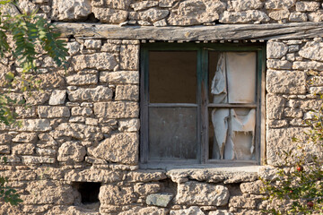 Old house and broken window with wooden lid