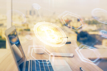 Double exposure of blockchain theme hologram and table with computer background. Concept of bitcoin crypto currency.