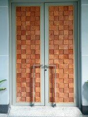 door and wall decorate by brick and wood.