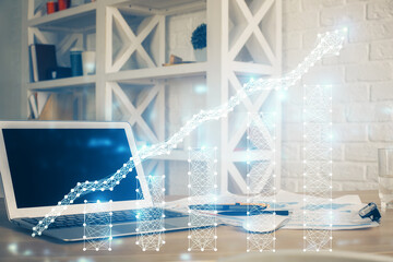 Financial chart drawing and table with computer on background. Multi exposure. Concept of...
