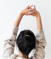 Naklejka premium Rear view of a young woman stretching her arms