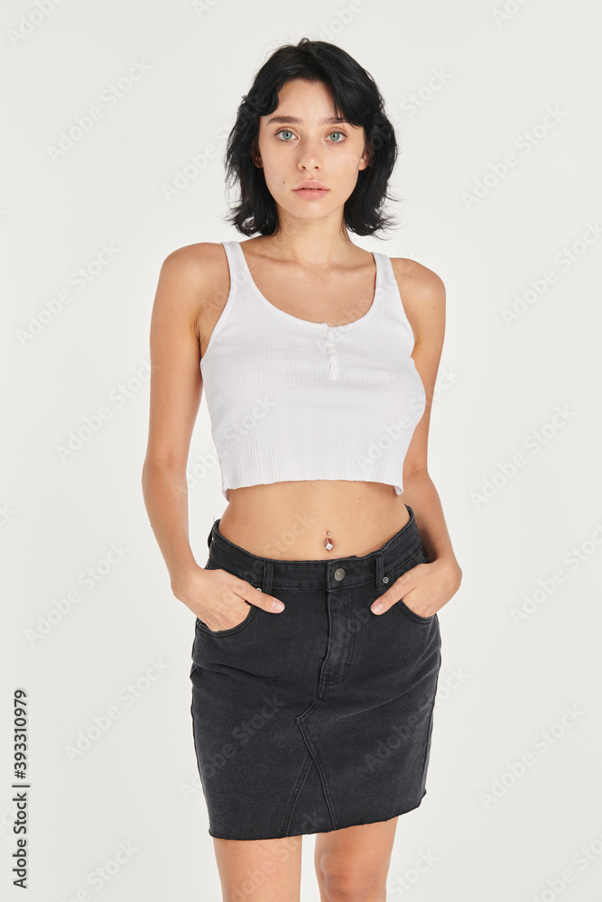 Poster cool woman in a black skirt and a white cropped top mockup