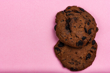 Cookies with chocolate chips on a pink background. View from above