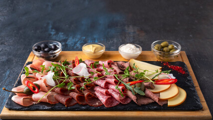 Different types of sausages and smoked meats. Text space