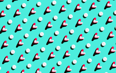 Colored pills, medical pills and capsules in a seamless pattern. View from above.