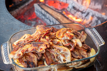 Fried bacon on open flame. Picnic