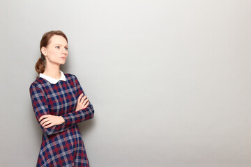 Portrait of serious girl holding arms crossed on chest