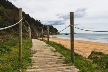 Wooden path next to the Laga's beach in Basque Country during a cloudy day