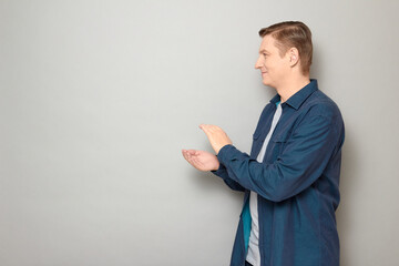 Portrait of happy man clapping his hands and smiling cheerfully